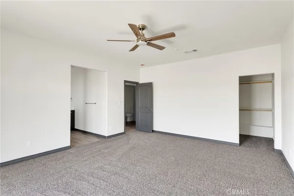 a view of a livingroom with a ceiling fan and entryway