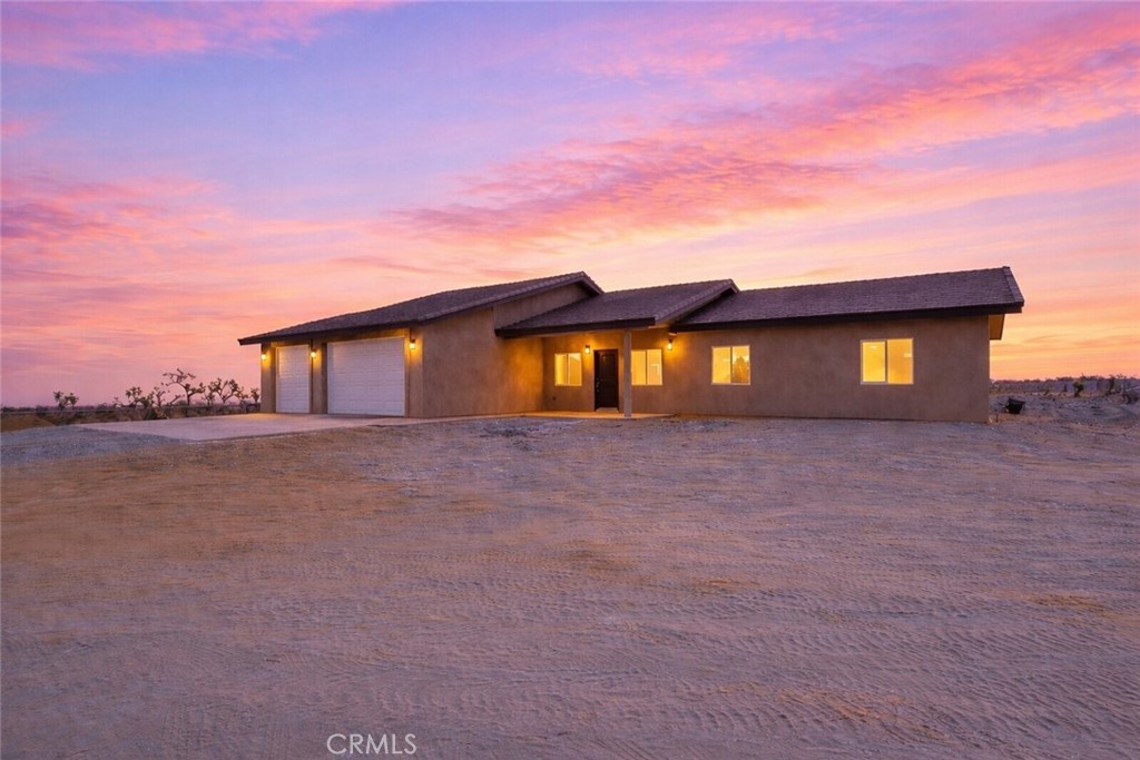 12015 Rosado Road Pinon Hills, CA 92372 - Photo 3 of 43 a front view of a house with a yard and lake