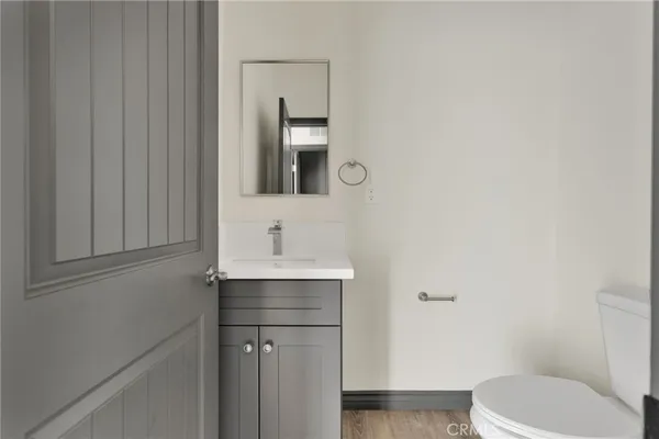 a bathroom with a toilet a sink and mirror