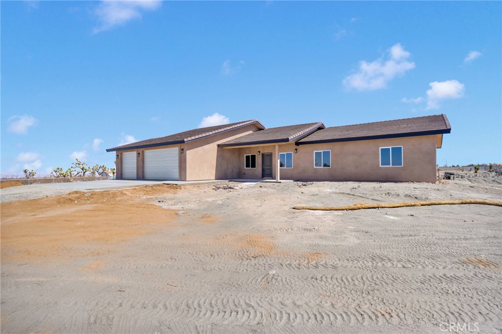 12015 Rosado Road Pinon Hills, CA 92372 - Photo 36 of 43 a front view of a house with a yard