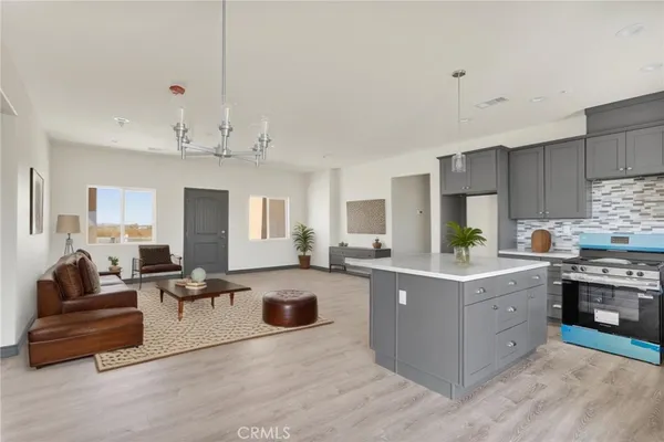 a large room with kitchen island lots of counter space and windows