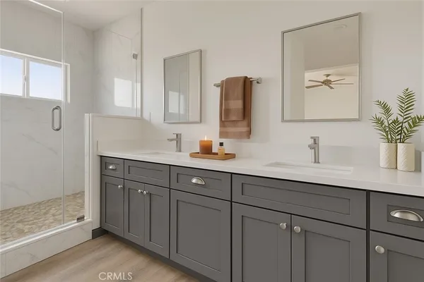 a bathroom with double vanity sinks and a mirror