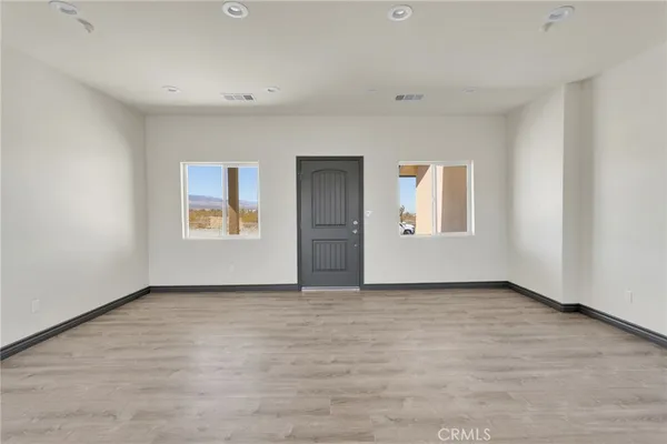 an empty room with windows and closet