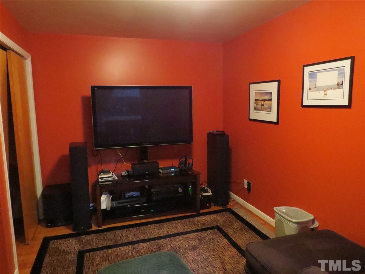 4308 Azalea Drive Raleigh, NC 27612 - Photo 11 of 18 a room with wooden floor and a flat screen tv