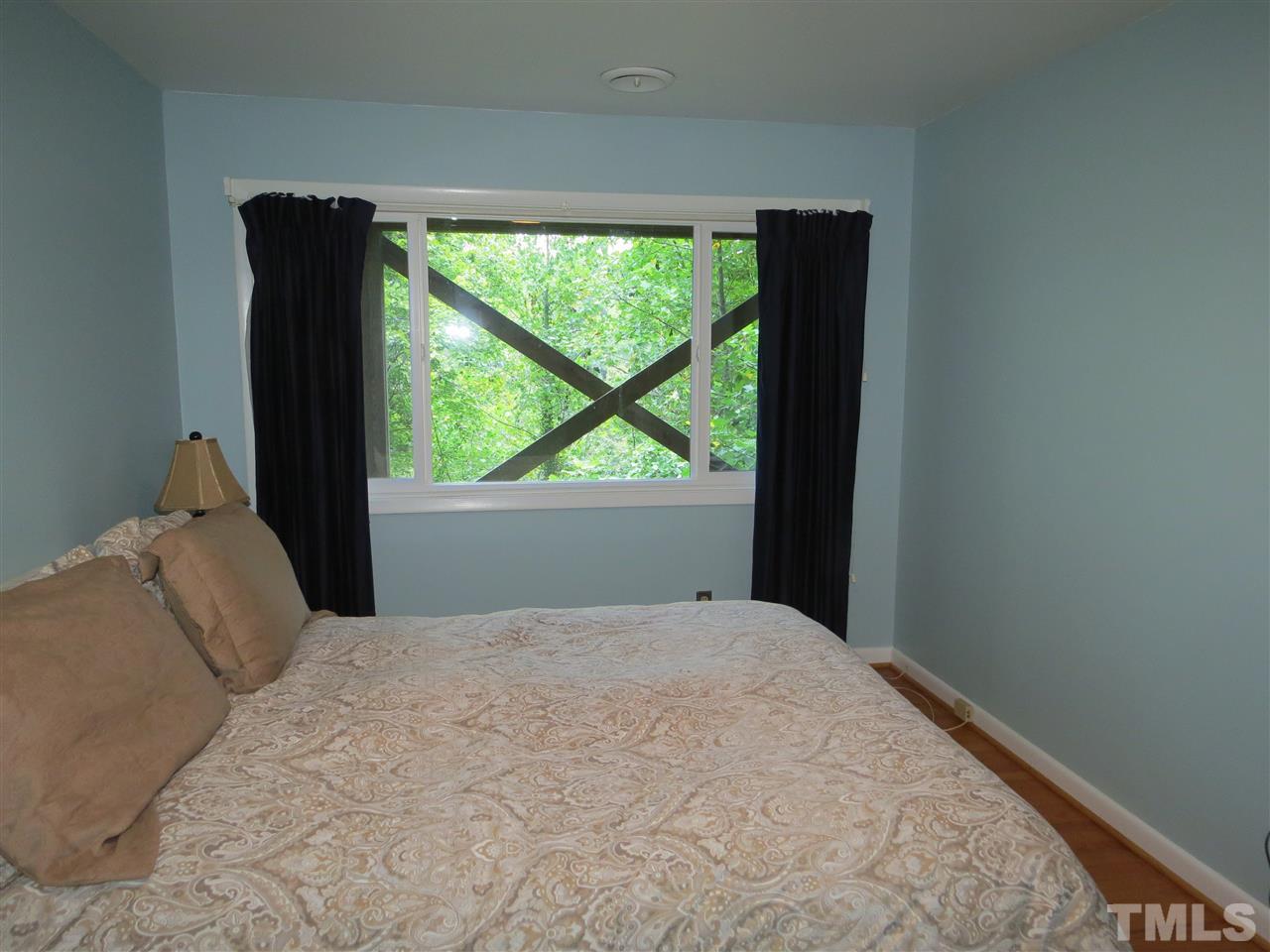 4308 Azalea Drive Raleigh, NC 27612 - Photo 12 of 18 a bedroom with a bed and large window