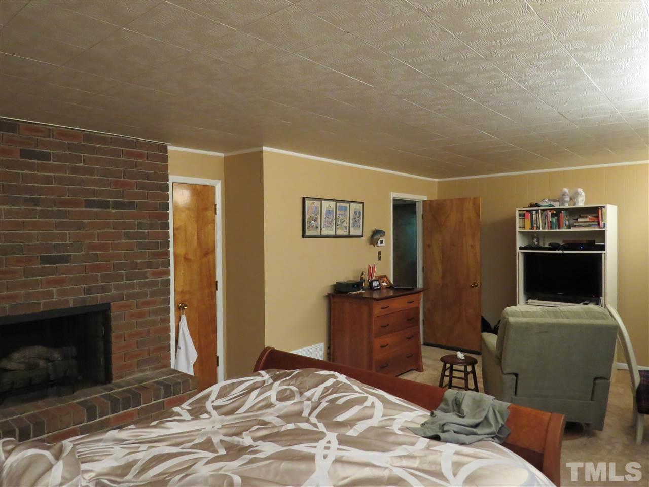 4308 Azalea Drive Raleigh, NC 27612 - Photo 10 of 18 a bedroom with a bed and furniture