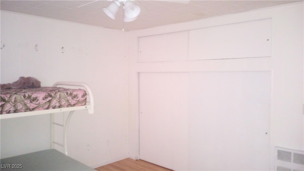 168 Lilith Avenue Pioche, NV 89043 - Photo 9 of 13 Unfurnished bedroom with light wood-type flooring, a closet, and a ceiling fan