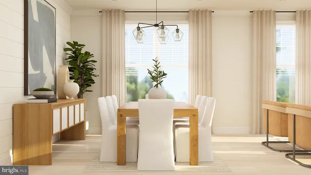 a dining room with chandelier and wooden floor