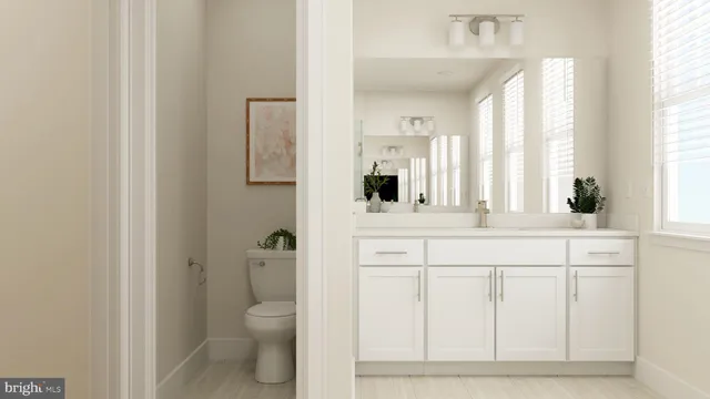 a bathroom with a sink a toilet and a window