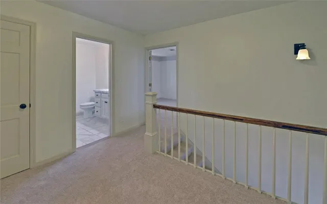 wooden floor in an empty room with a chandelier fan