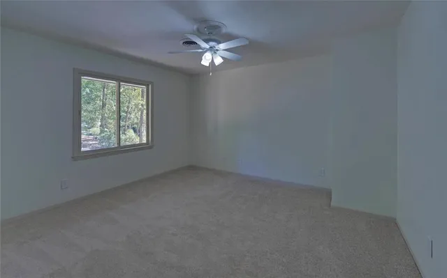 a bathroom with a granite countertop sink a toilet and mirror