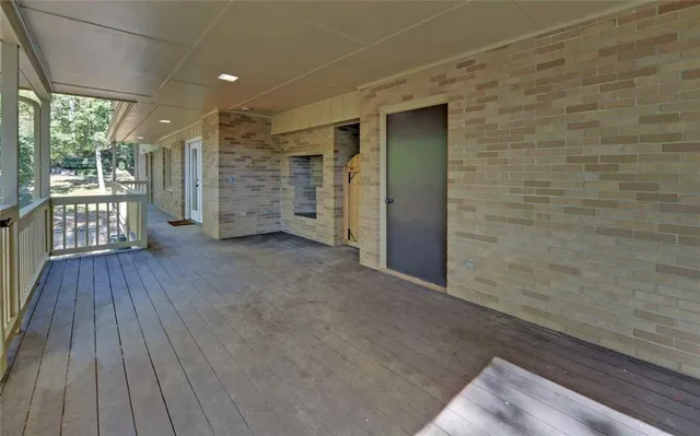a view of an empty room with glass door and balcony
