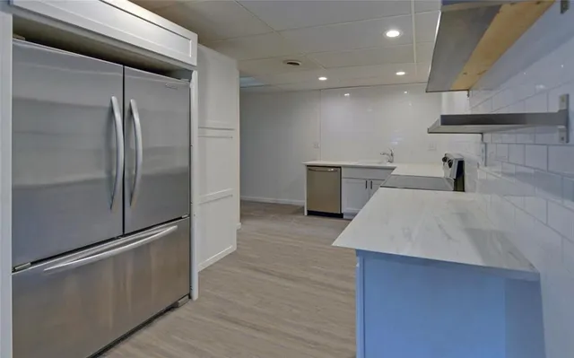 a bathroom with a shower a mirror and a sink