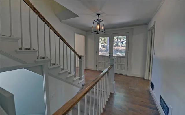 a view of entryway and hall with wooden floor