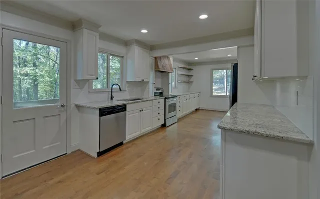 a kitchen with a sink stove and cabinets