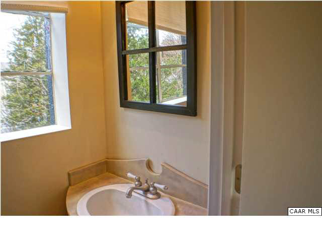 5445 Louisa Road Keswick, VA 22947 - Photo 24 of 39 a bathroom with a sink a window and a mirror