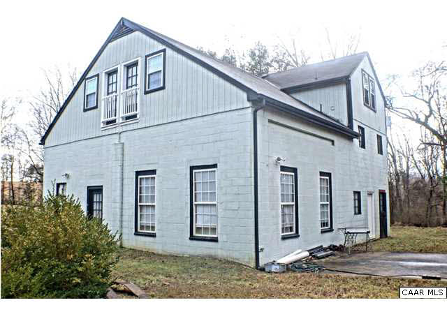 5445 Louisa Road Keswick, VA 22947 - Photo 3 of 39 a view of a white house with large windows