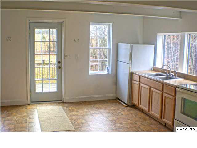 5445 Louisa Road Keswick, VA 22947 - Photo 7 of 39 a living room with stainless steel appliances kitchen island granite countertop a stove a refrigerator and cabinets