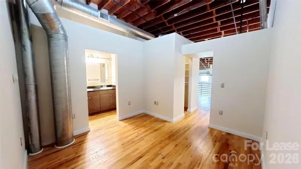 a view of a room with wooden floor