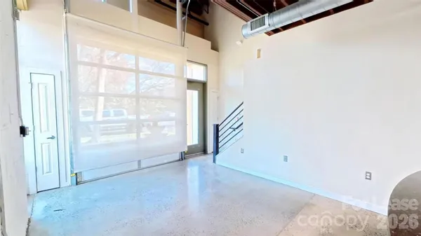 a view of a hallway with wooden floor and windows