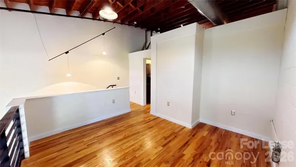 a view of a room with wooden floor