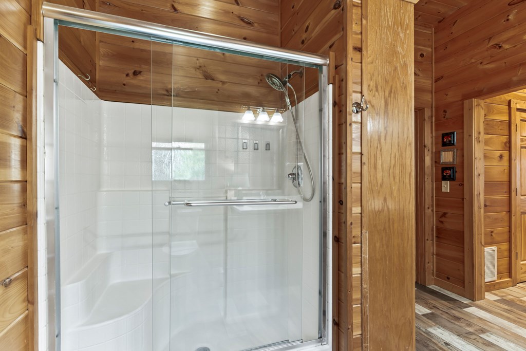 45 Turning Lay Road Morganton, GA 30560 - Photo 29 of 48 a bathroom with a glass shower door and mirror