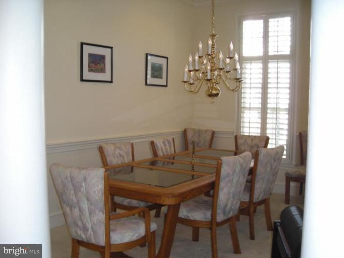 321 Cameron Station Boulevard Alexandria, VA 22304 - Photo 3 of 19 a view of a dining room with furniture and chandelier