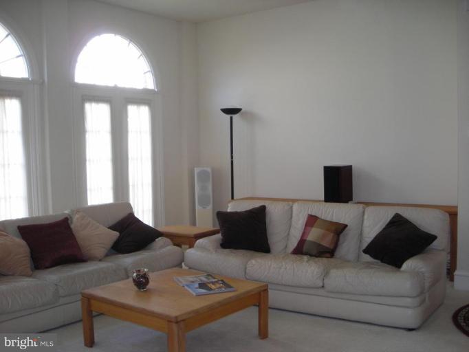 321 Cameron Station Boulevard Alexandria, VA 22304 - Photo 4 of 19 a living room with furniture and a large window
