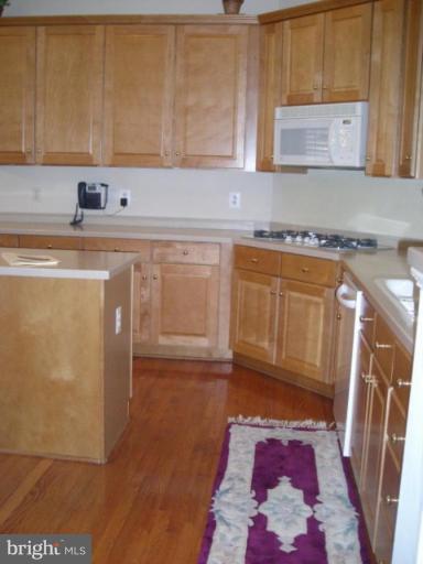321 Cameron Station Boulevard Alexandria, VA 22304 - Photo 5 of 19 a kitchen with granite countertop a sink and a stove top oven