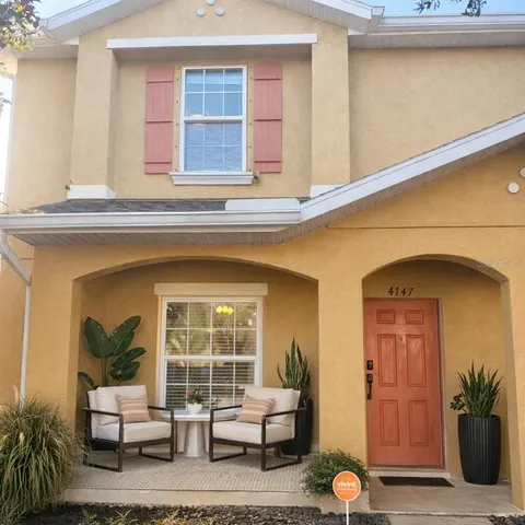 a living room with furniture and potted plant