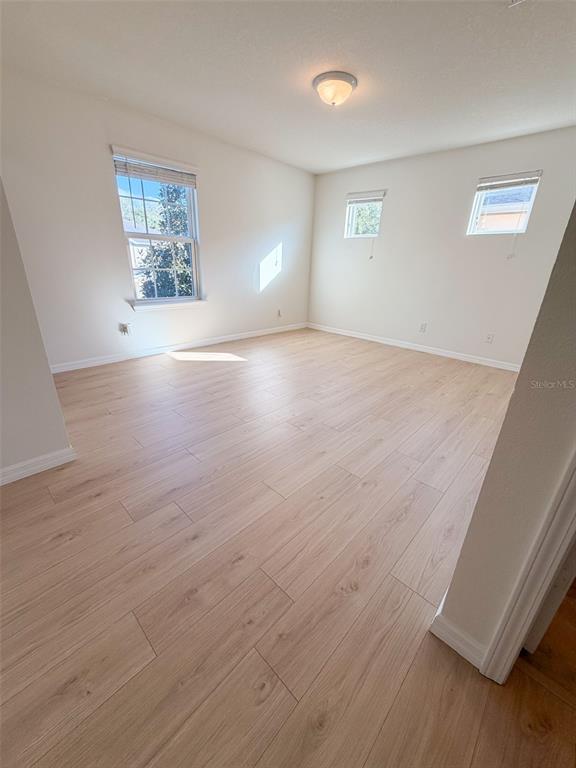 4747 Chatterton Way Riverview, FL 33578 - Photo 17 of 24 an empty room with wooden floor and windows