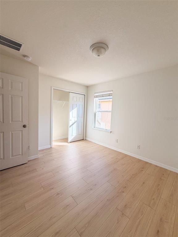 4747 Chatterton Way Riverview, FL 33578 - Photo 22 of 24 a view of an empty room with wooden floor and windows
