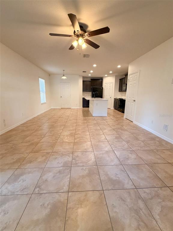 4747 Chatterton Way Riverview, FL 33578 - Photo 8 of 24 a view of an empty room with a ceiling fan and window