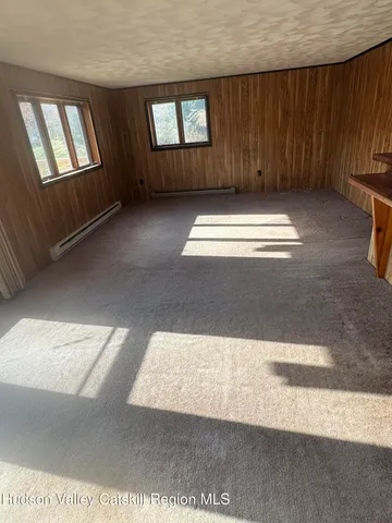 a view of a room with wooden floor and staircase
