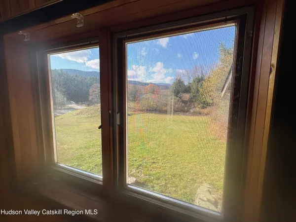 an aerial view of a house with a yard and lake