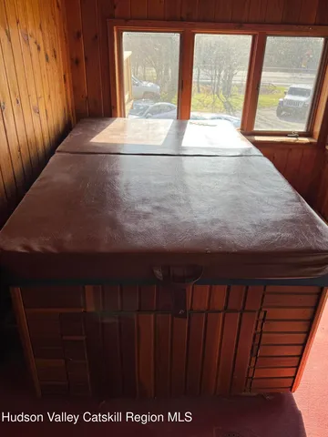 a view of a room with large windows and wardrobe