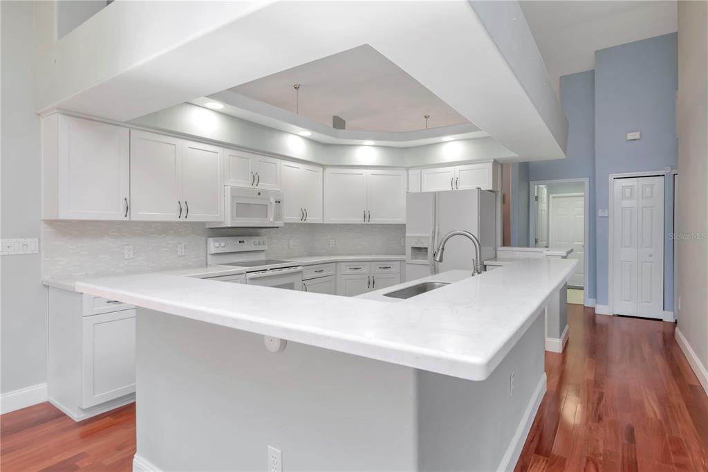 4938 Yellowstone Drive New Port Richey, FL 34655 - Photo 11 of 51 a kitchen with kitchen island a sink and wooden floor