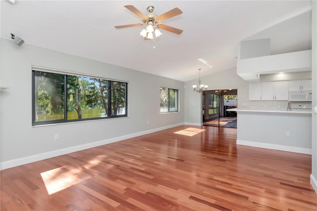 4938 Yellowstone Drive New Port Richey, FL 34655 - Photo 12 of 51 a view of an empty room with window and wooden floor