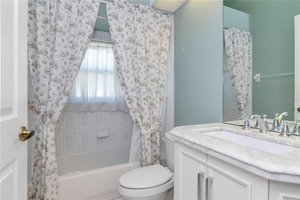4938 Yellowstone Drive New Port Richey, FL 34655 - Photo 25 of 51 a bathroom with a granite countertop sink a toilet and shower