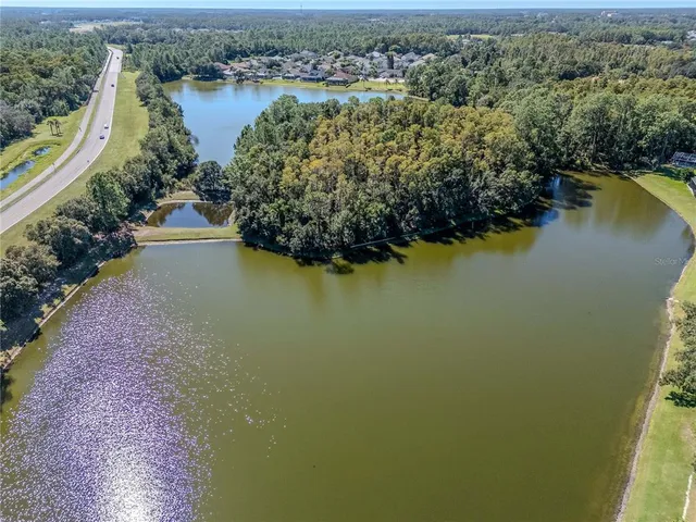 an aerial view of residential house with outdoor space and lake view