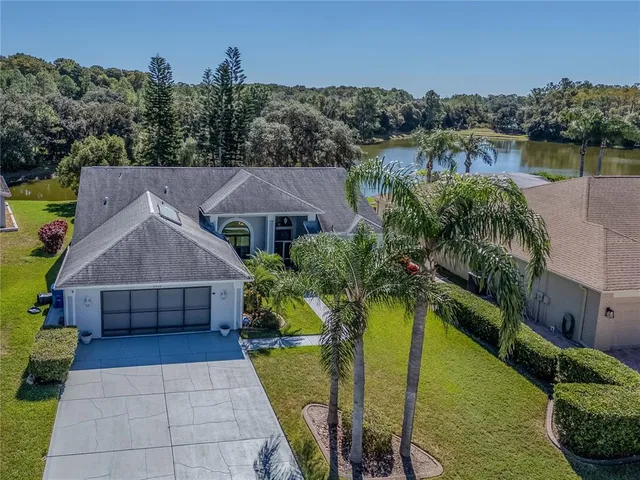 a aerial view of a house with swimming pool and a yard