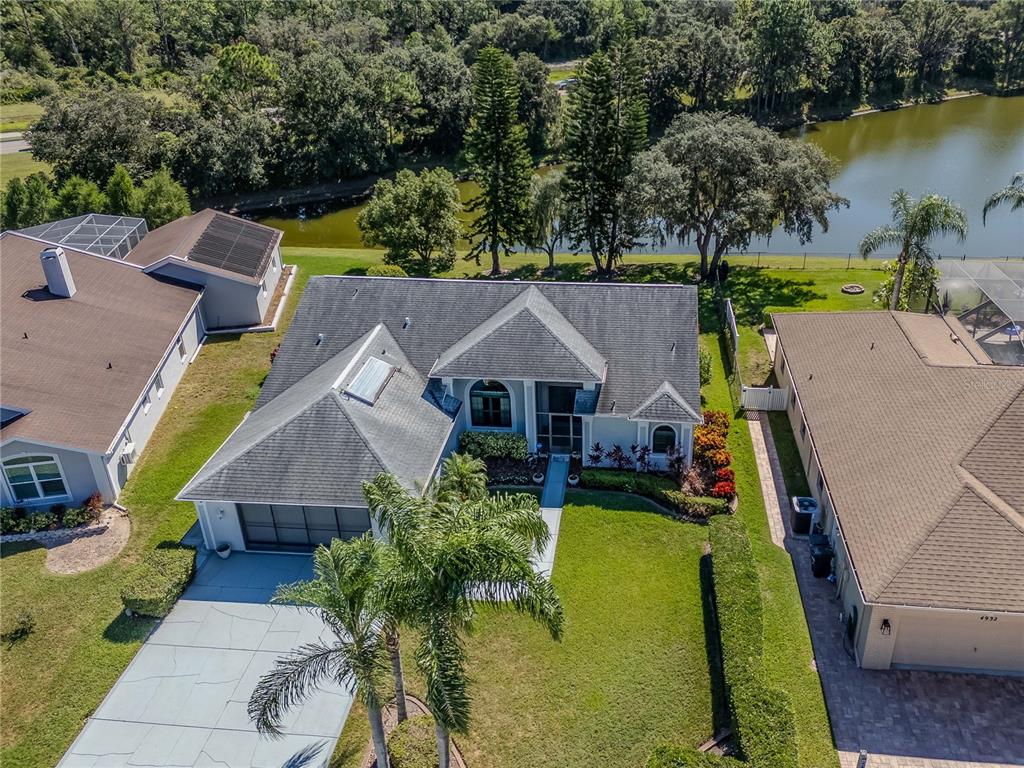 4938 Yellowstone Drive New Port Richey, FL 34655 - Photo 41 of 51 an aerial view of a house with swimming pool and garden