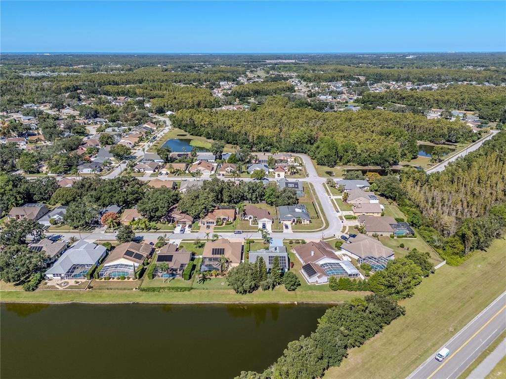 4938 Yellowstone Drive New Port Richey, FL 34655 - Photo 45 of 51 an aerial view of residential houses with outdoor space and lake view