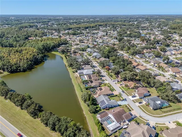 a front view of a house with garden and trees
