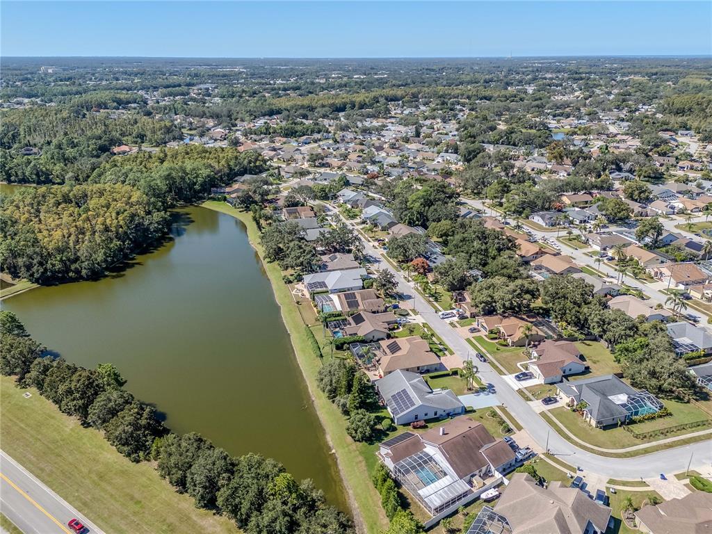 4938 Yellowstone Drive New Port Richey, FL 34655 - Photo 46 of 51 an aerial view of a house with a lake view