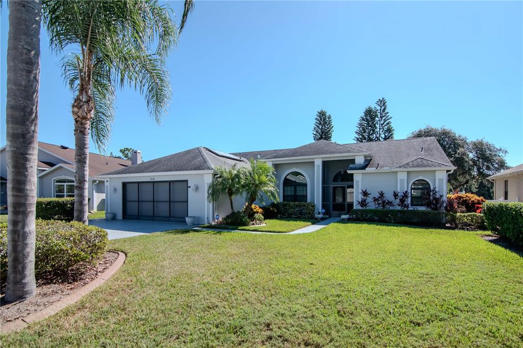 4938 Yellowstone Drive New Port Richey, FL 34655 - Photo 49 of 51 a view of a house with a yard and potted plants