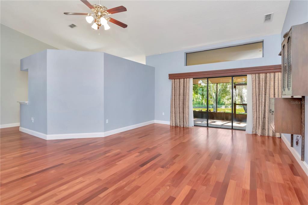 4938 Yellowstone Drive New Port Richey, FL 34655 - Photo 7 of 51 a view of an empty room with wooden floor and a window