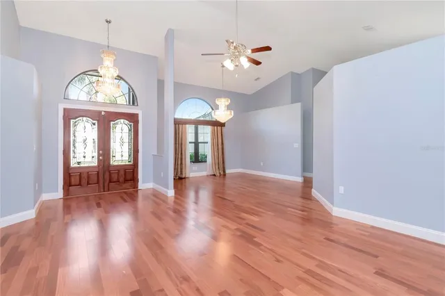 a view of a room with wooden floor fan and window