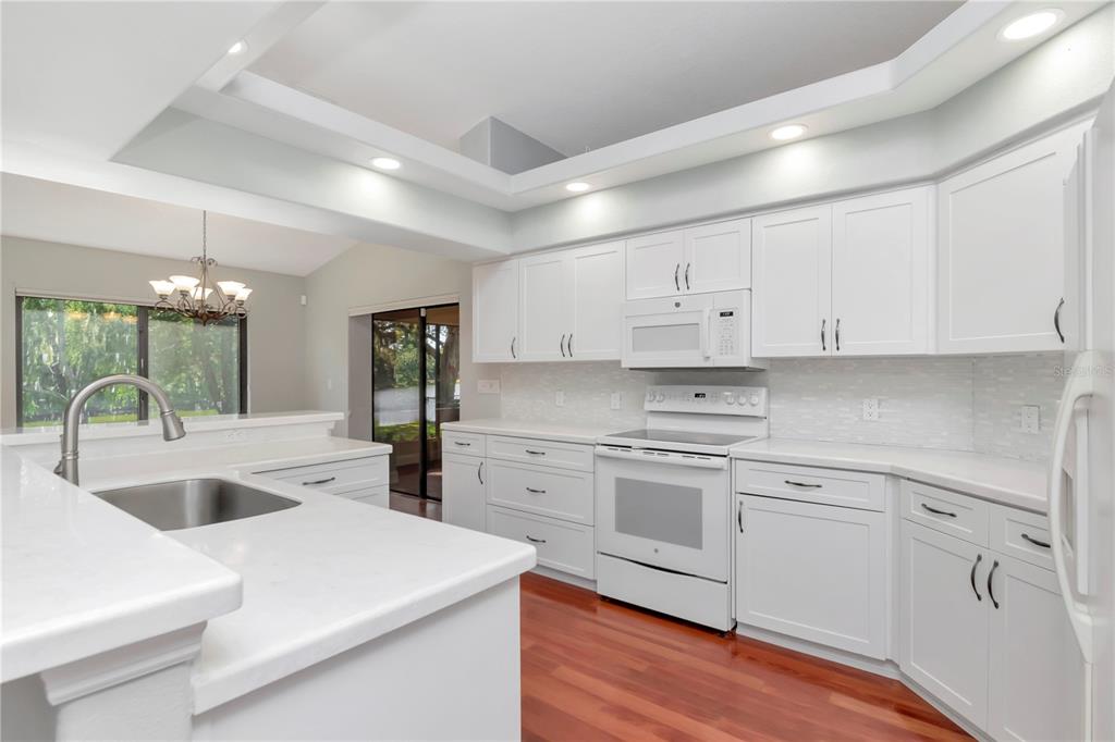 4938 Yellowstone Drive New Port Richey, FL 34655 - Photo 9 of 51 a kitchen with white cabinets and white appliances