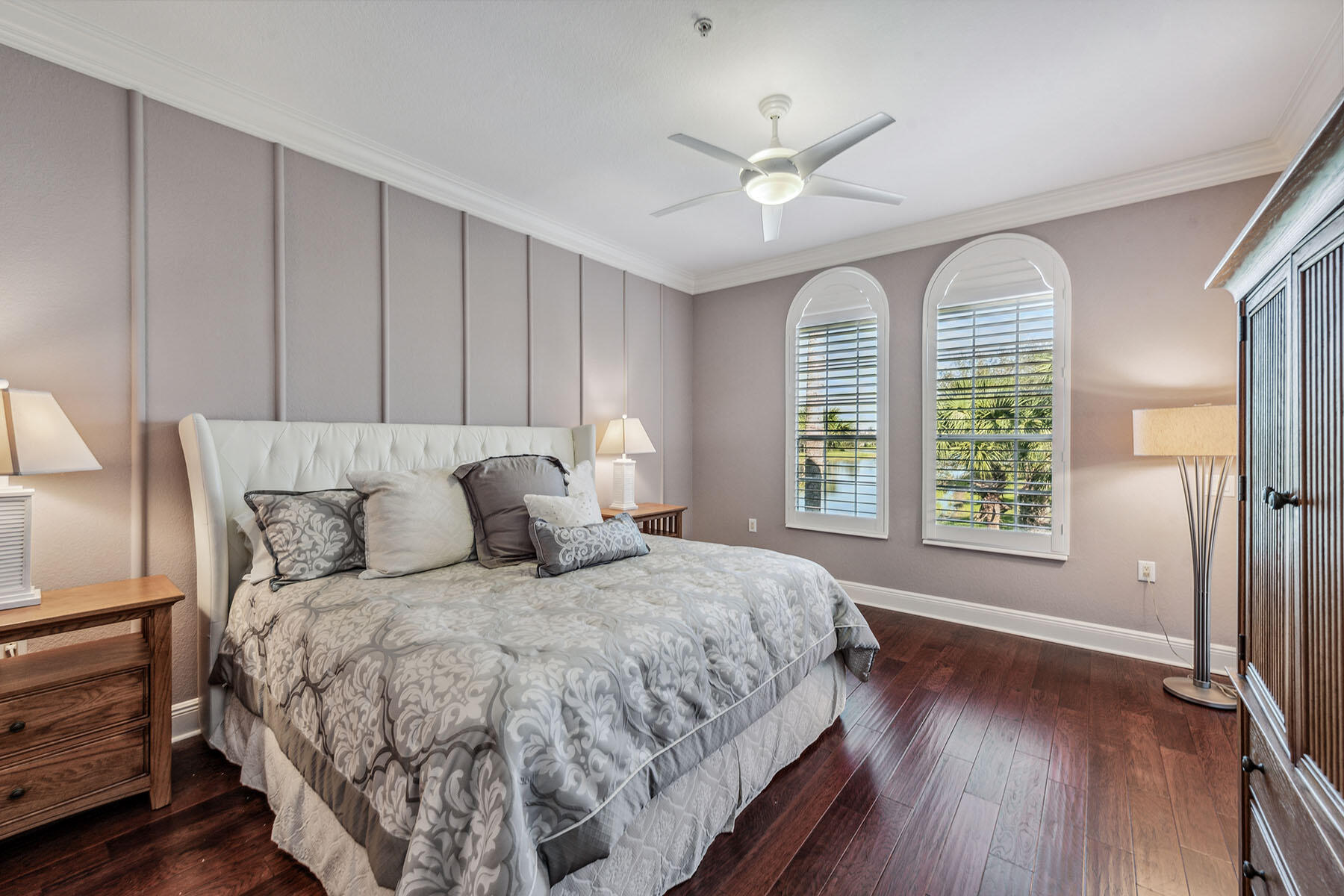 3189 Aviamar Circle, Unit 202 Naples, FL 34114 - Photo 13 of 50 a bedroom with a large bed and a chandelier